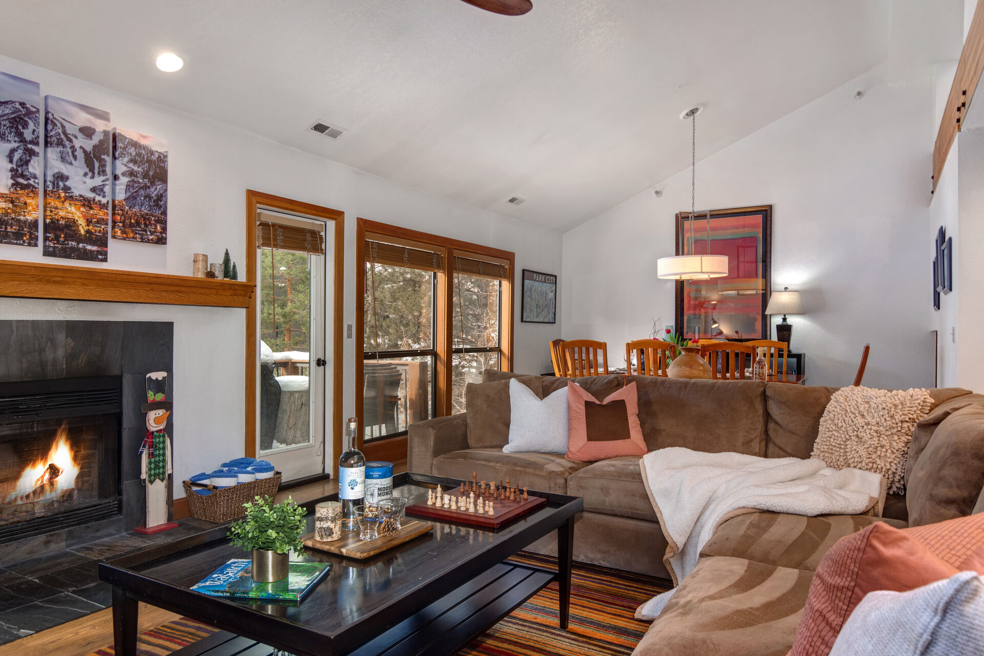 Living Room with plush modern sectional sofa, wood-burning fireplace, 55