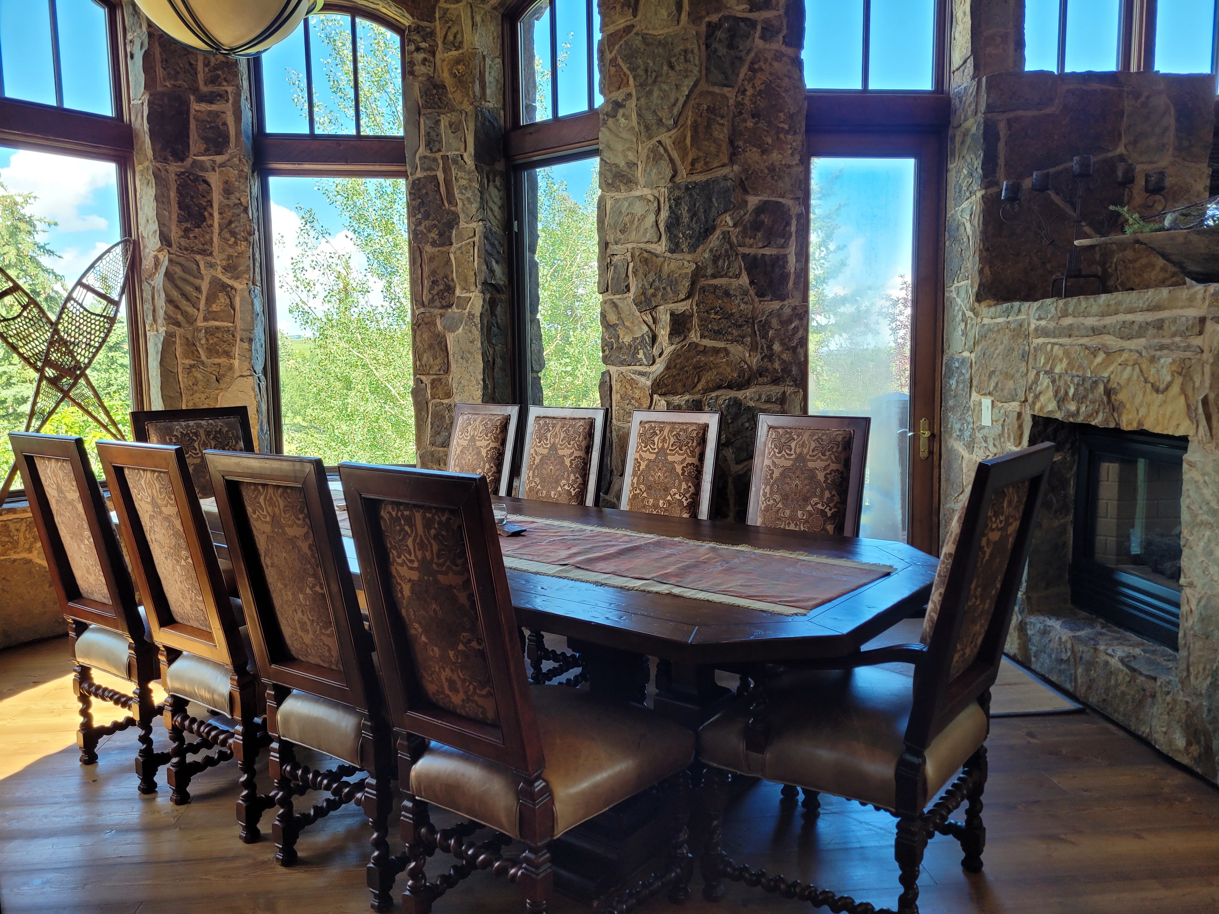 Luxury dining room with large table and stone walls