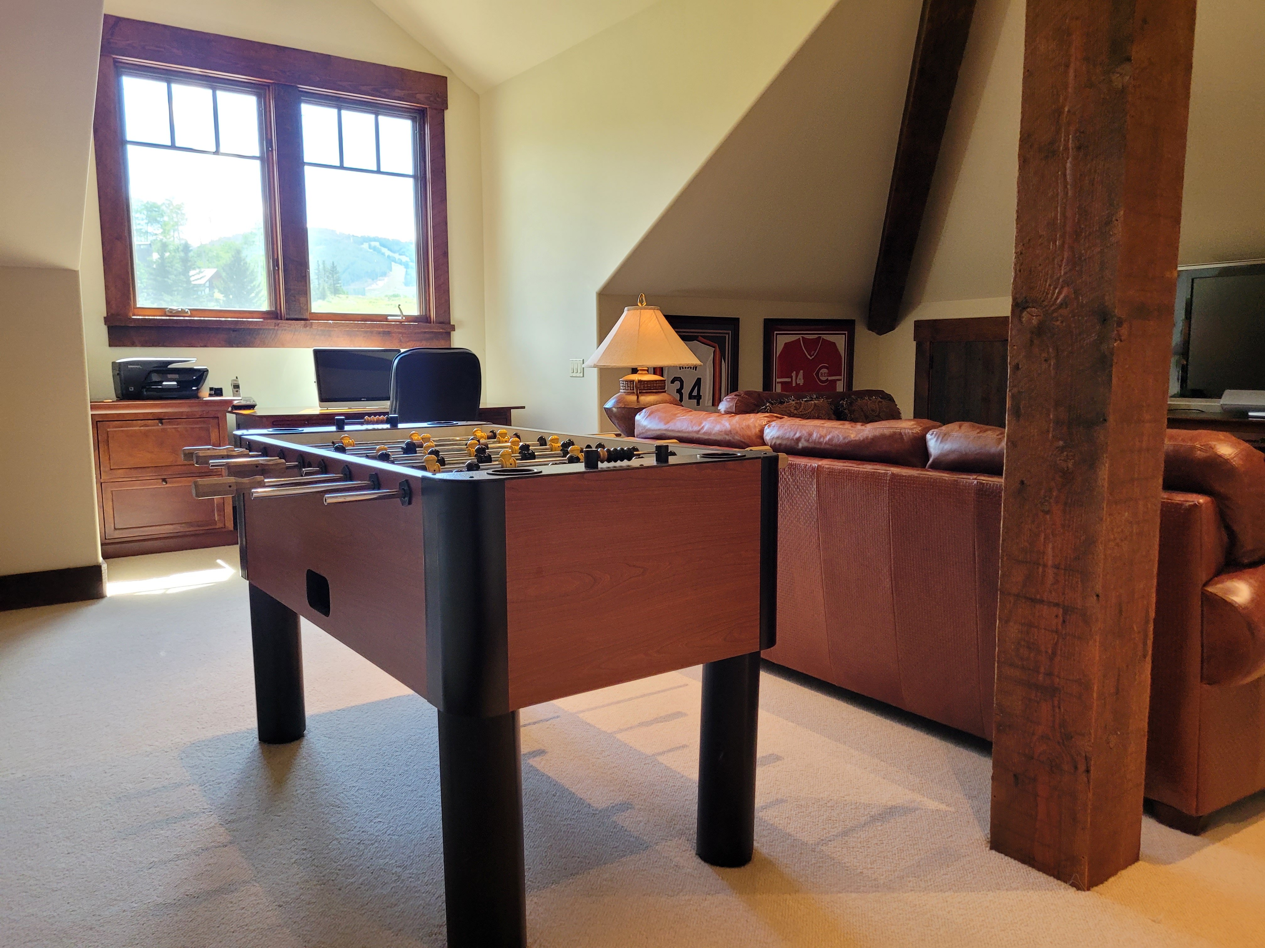 Game room with Foosball table and leather couches