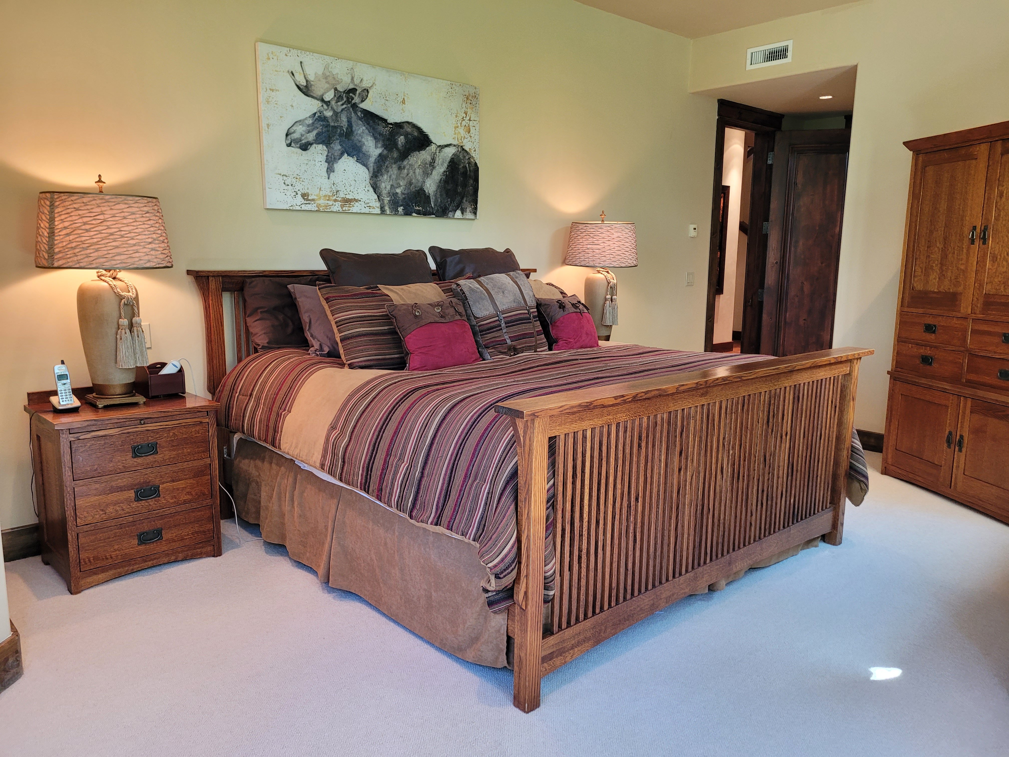 Large bed with wood frame and wood furniture