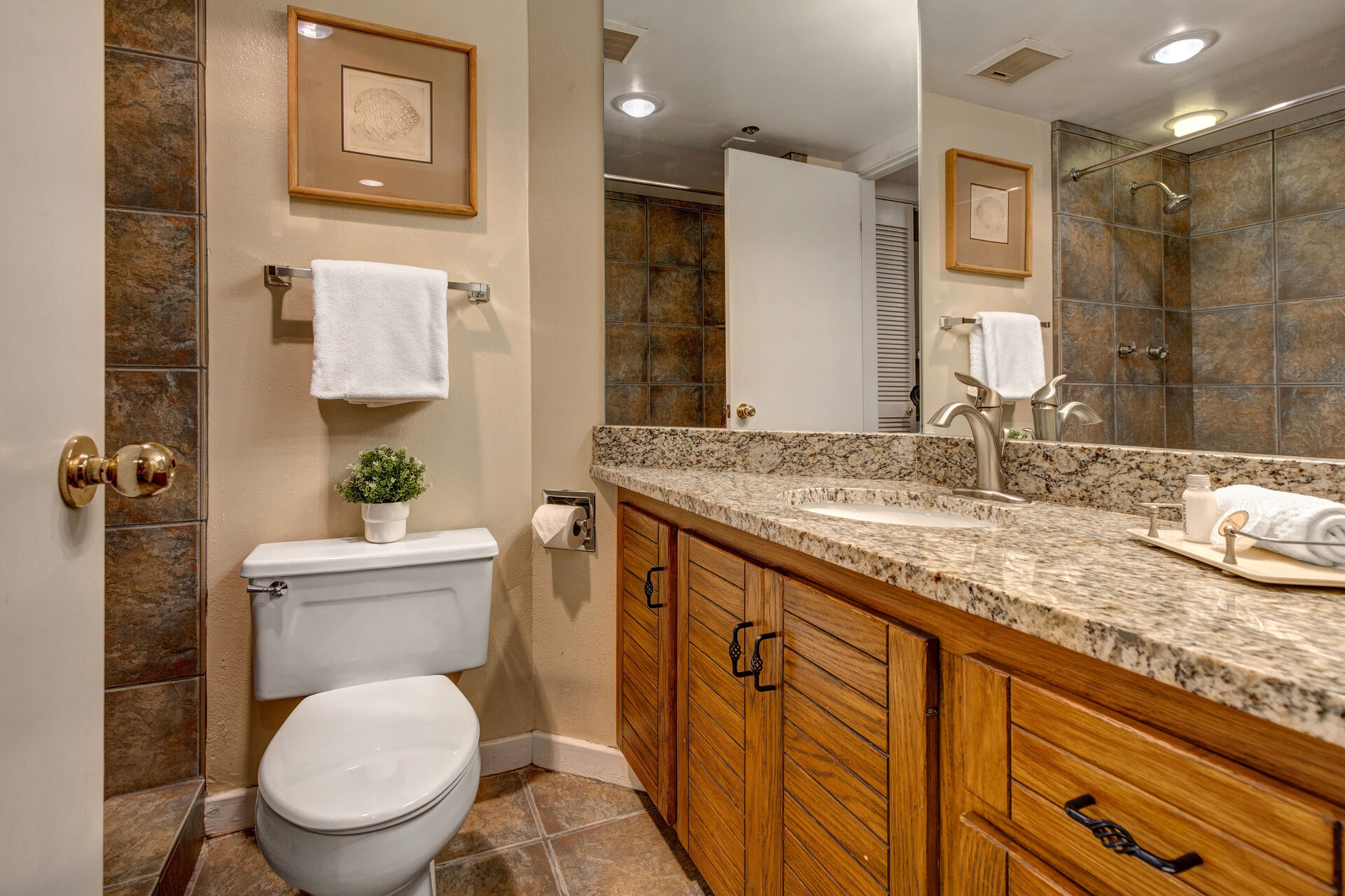 Shared Full Bathroom with tiled shower and private laundry closet access