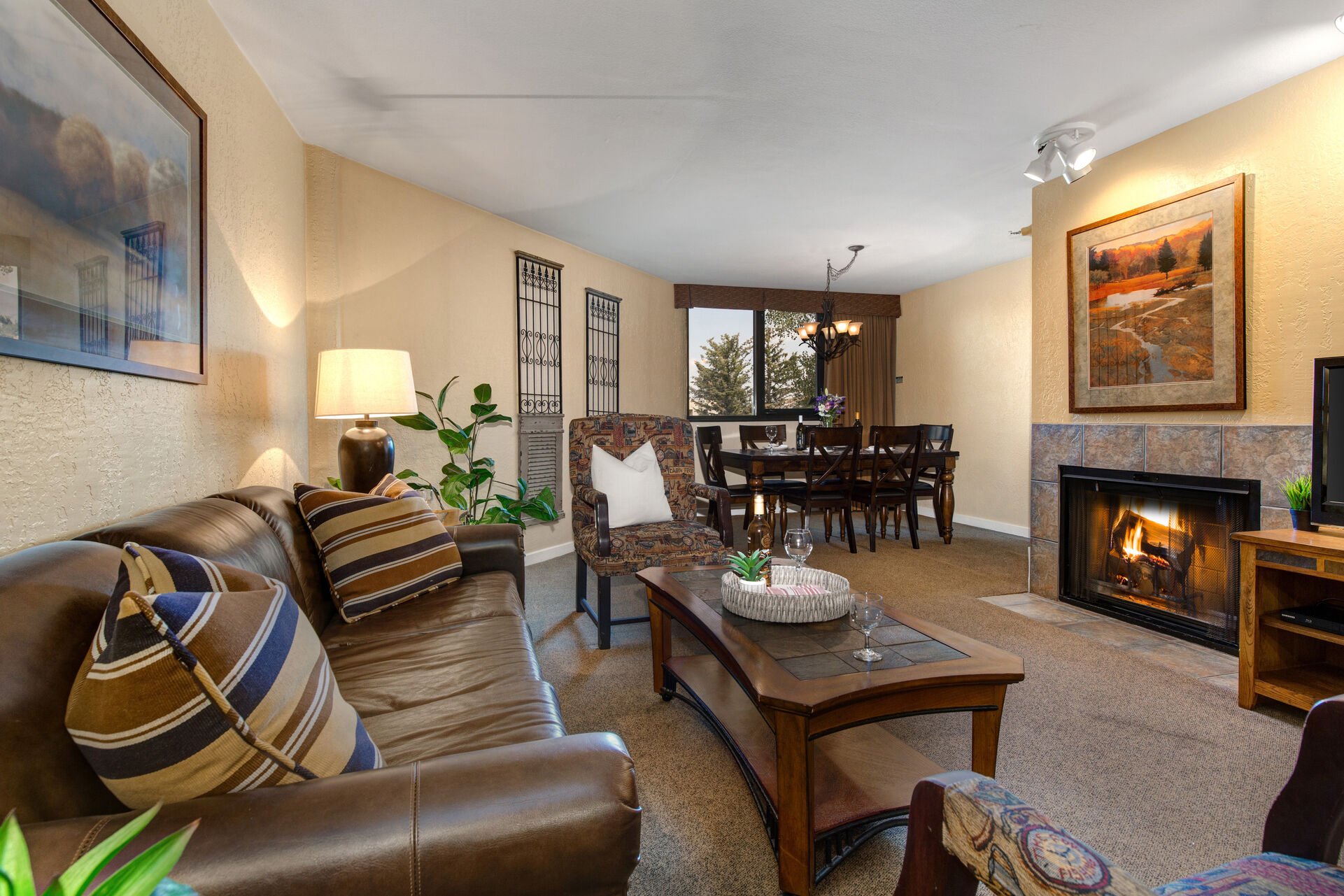 Living Room with wood-burning fireplace, plush leather furnishings with sleeper sofa, and 39