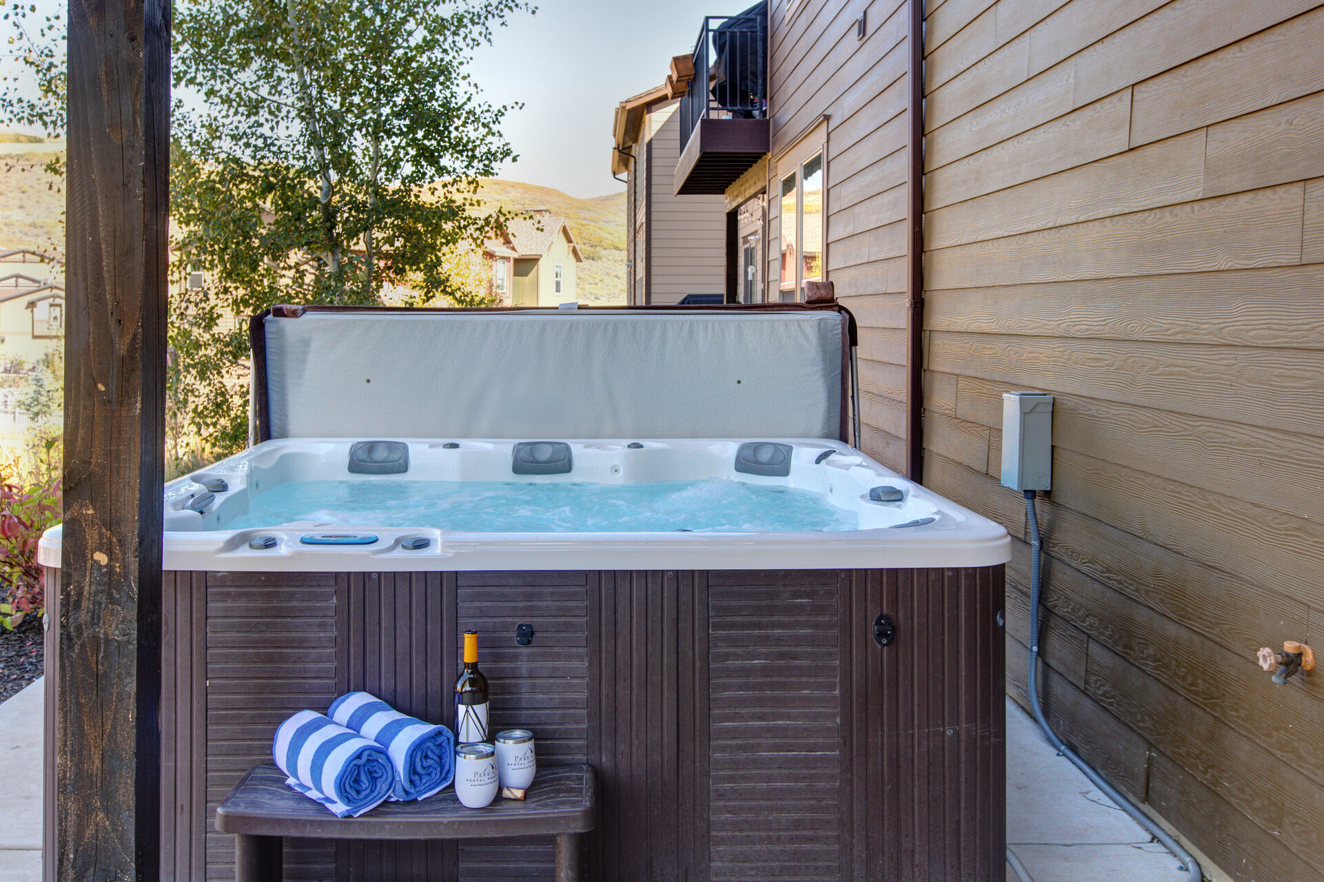 Lower Level Private Hot Tub Patio with seating for two, hot tub, and beautiful surrounding views