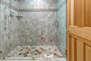Master Bathroom with dual vanities, jetted soaking tub, and large tiled shower