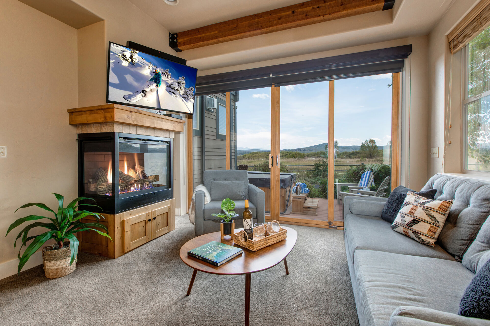 Living Room with plush couch, armchair, gas fireplace, 50