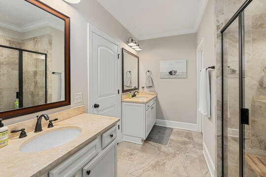 The elegant Master Bathroom has a glassed-in shower, separate vanities and a private water closet.
