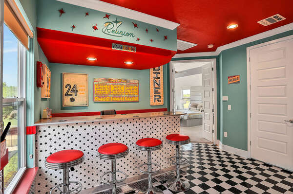 The retro diner-themed counter offers barstool seating for 4