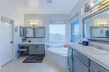 Wow to the dual vanities and luxurious garden tub in the primary bath.