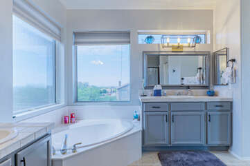 Vanities in the primary bath allows 2 to simultaneously primp for an exciting night on the town.