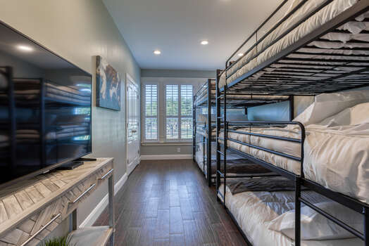 Main Level Bunk Room with 6 Queen Beds, a 65