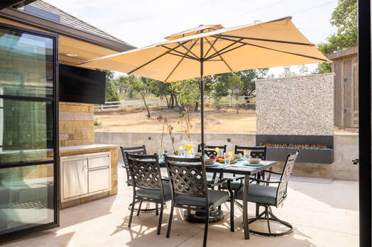 Outdoor Dining with a Gas Fireplace, Mini Fridge and Smart TV