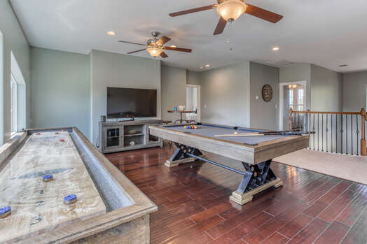Upper Level Game Room with a Custom Pool Table and 14 Ft. Shuffleboard Table, a 65