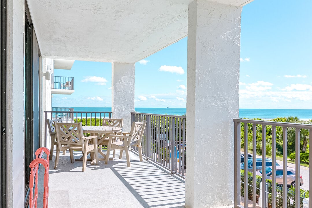 Spacious balcony with a dining set and a refreshing ocean breeze