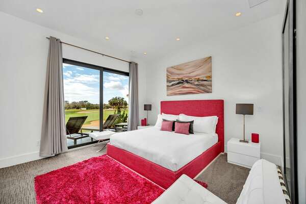 This bedroom with king-sized bed has a private balcony with golf course views