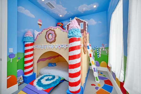 Kids will adore the Candy Land-themed bedroom with a set of double bunk beds