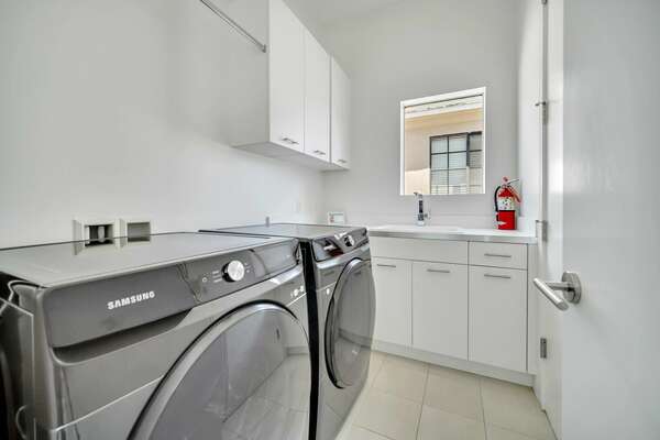 The laundry room includes a full-sized washer and dryer for convenience