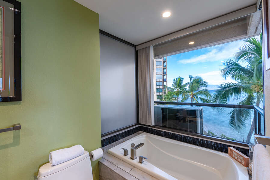 Enjoy a relaxing bath while looking down below at the beach.