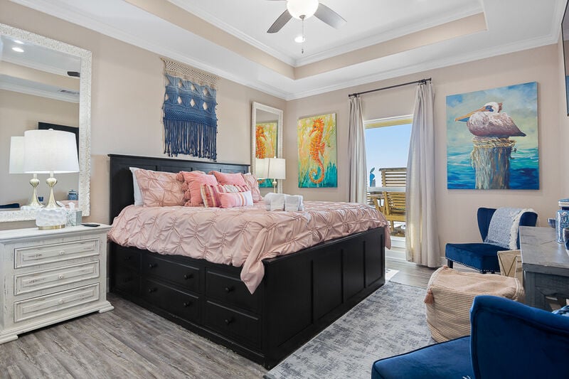 Master king room with a storage bed, additional seating and amazing beach views