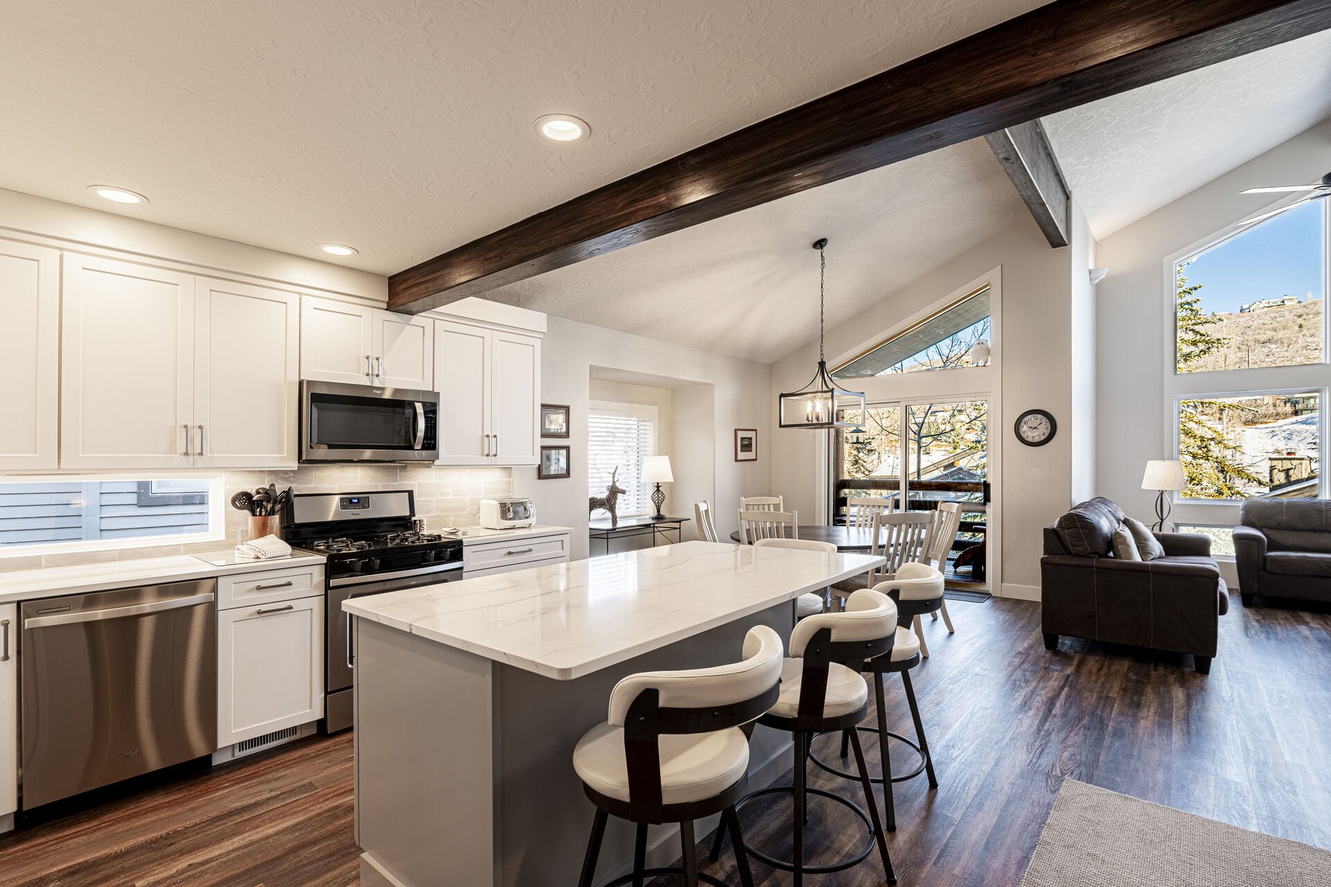 Fully Equipped Kitchen with Stainless Steel Appliances, and Bar Seating for Four