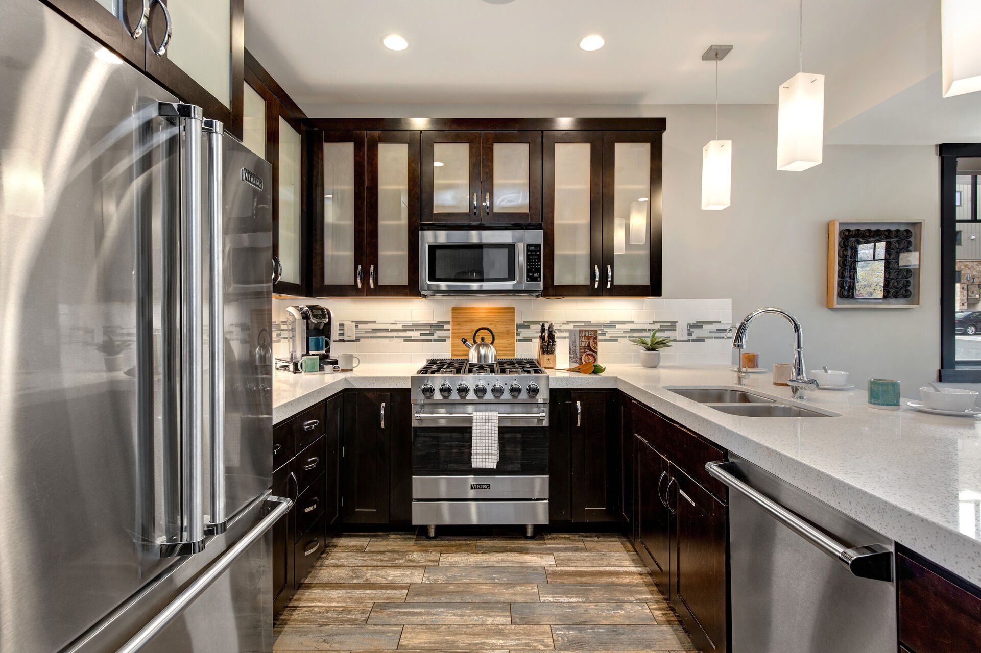 Fully Equipped Kitchen with beautiful stone countertops, stainless steel Viking appliances, and bar seating for four