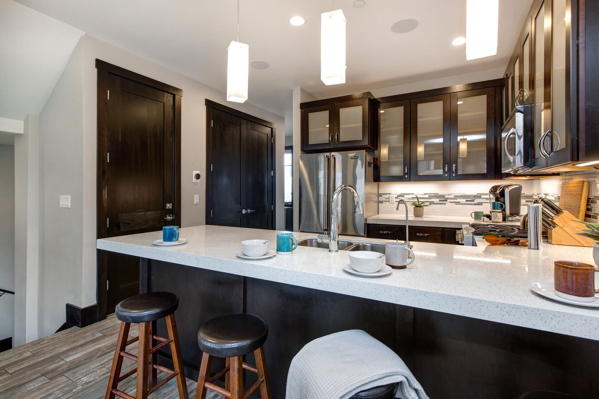 Fully Equipped Kitchen with beautiful stone countertops, stainless steel Viking appliances, and bar seating for four