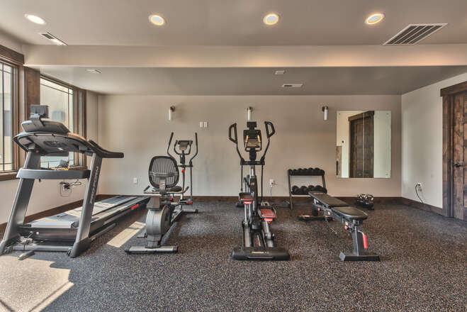 Clubhouse with ample seating and furnishings, fully equipped gym, pool, and hot tub