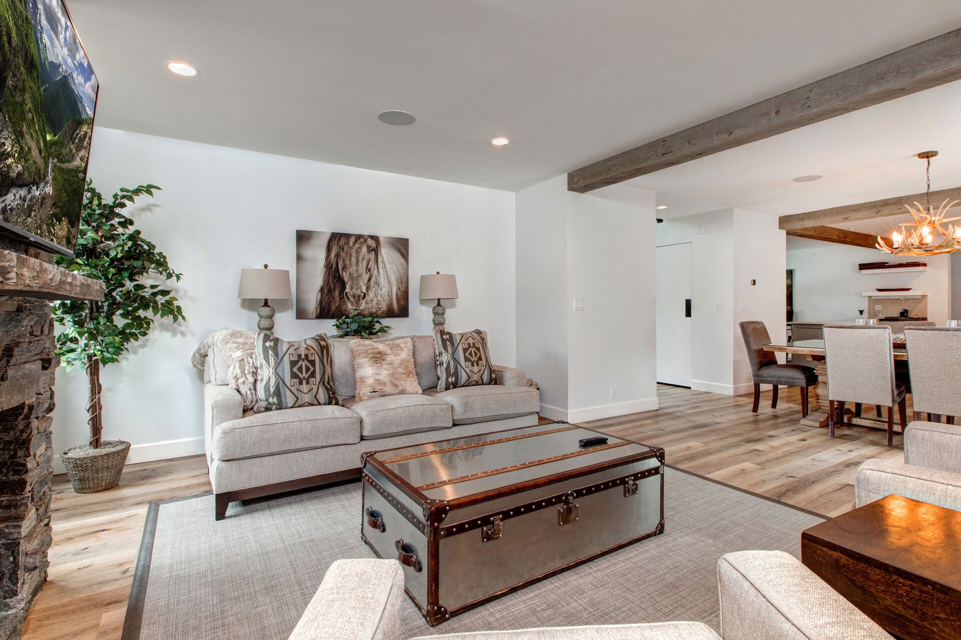 Living Room with a Gas Fireplace and Smart TV, opens up into dining room