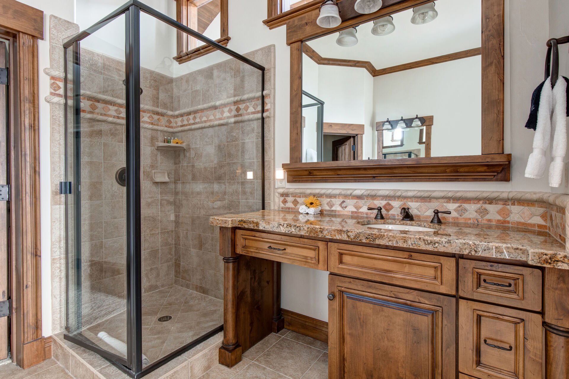 Master Bathroom with double vanities, tiled shower, walk-in closet, and jetted tub