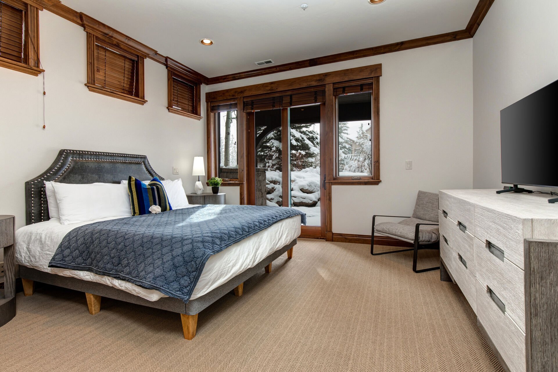 Lower Level Bedroom 4 with king bed, Samsung smart TV, Hot tub patio access, and en suite bathroom