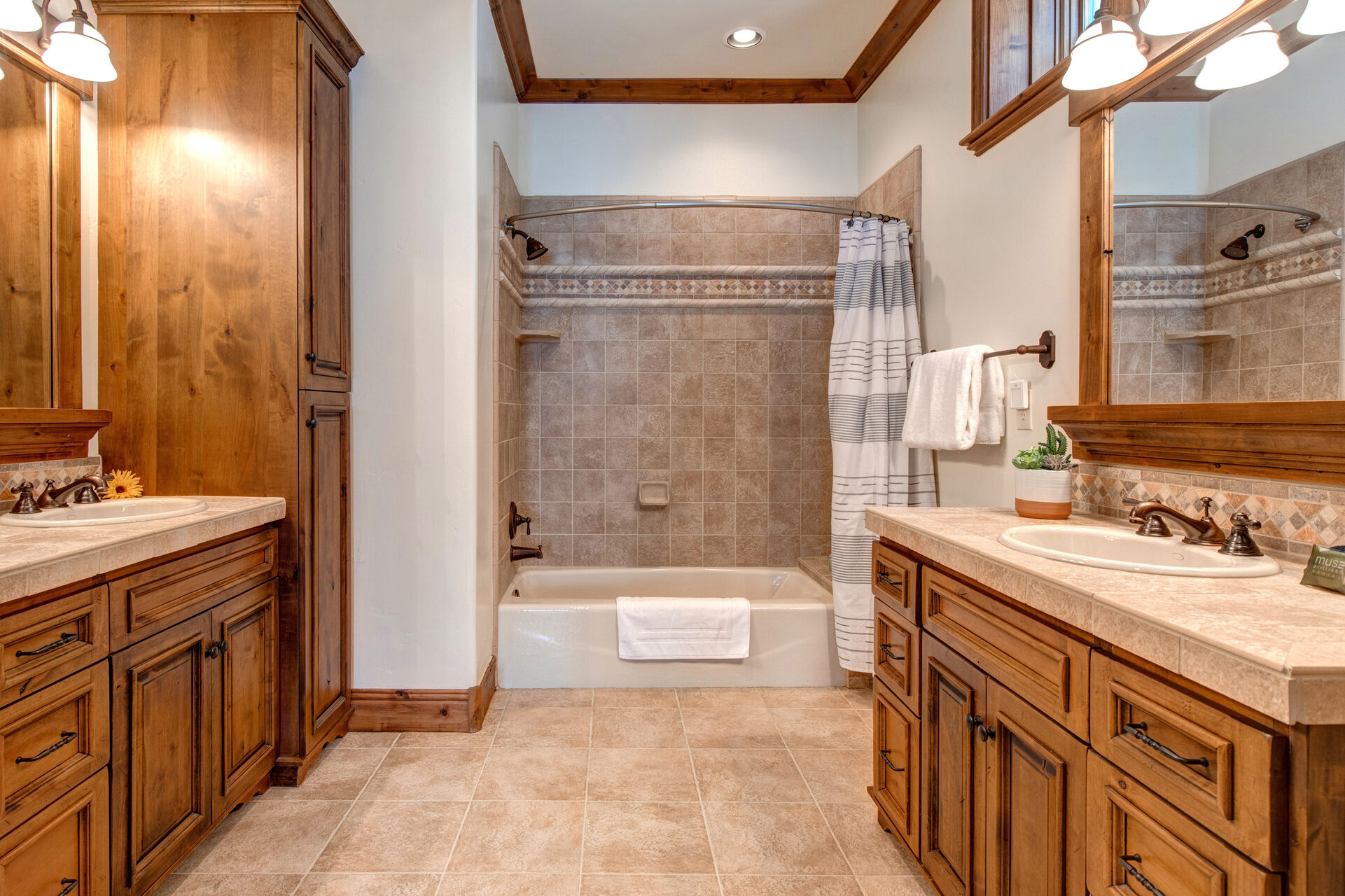 Bedroom 4 bathroom with double vanities, and tub/shower combo