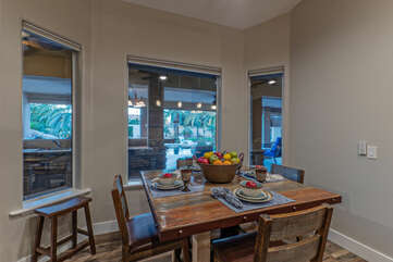 Sip your morning coffee in the breakfast nook which overlooks the outdoor kitchen and pool.