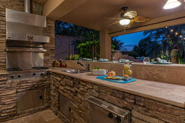 No kidding! It's an outdoor kitchen with high end appliances and everything the chef needs to prepare delectable eats.