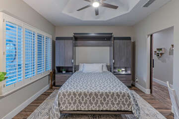 Bedroom 2 doubles as a sleeping area and work space with a queen size Murphy bed, TV and desk for your remote work.
