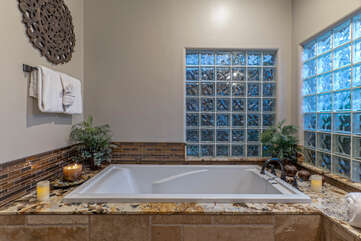 Luxurious garden tub invites tranquil soaks to soothe your weary muscles and eliminate stress.