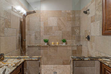 Walk-in tile shower in primary suite welcomes you for a refreshing rinse after a day on the golf course or trails.