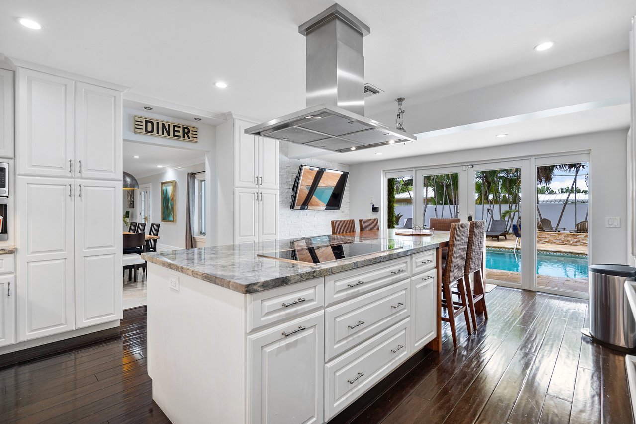 Kitchen with its own seating for casual meals and access to the heated pool.