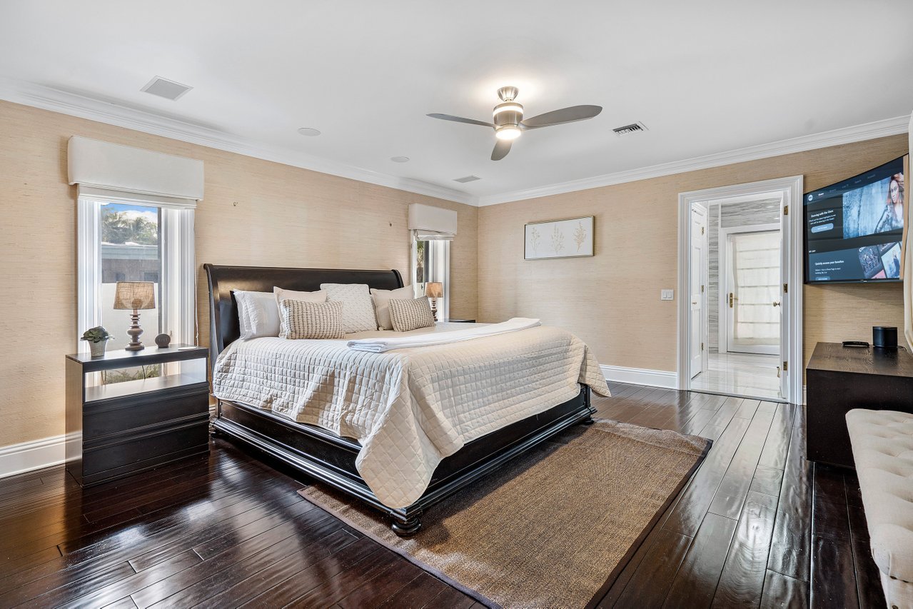 The master bedroom is located on the ground floor. It features a king-sized bed, a Smart TV, and easy access to the heated pool.