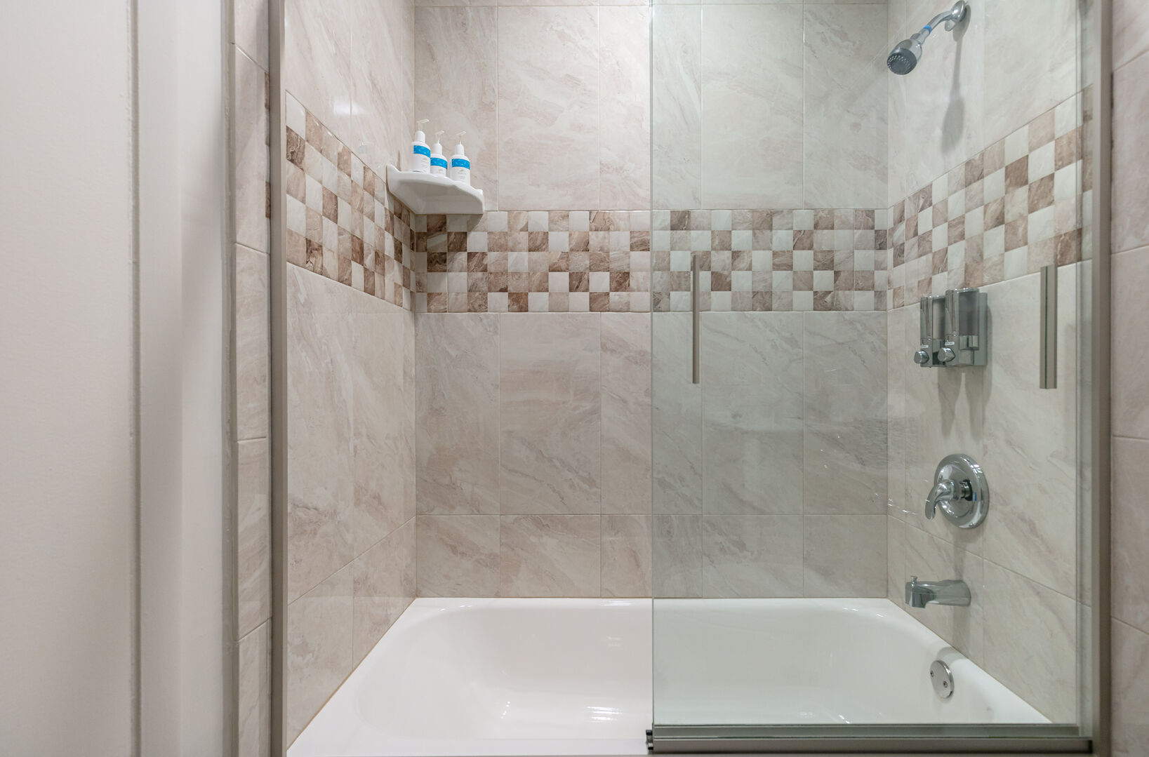 There's a tub/shower combo in the master bathroom, with beautiful tiles on the walls.