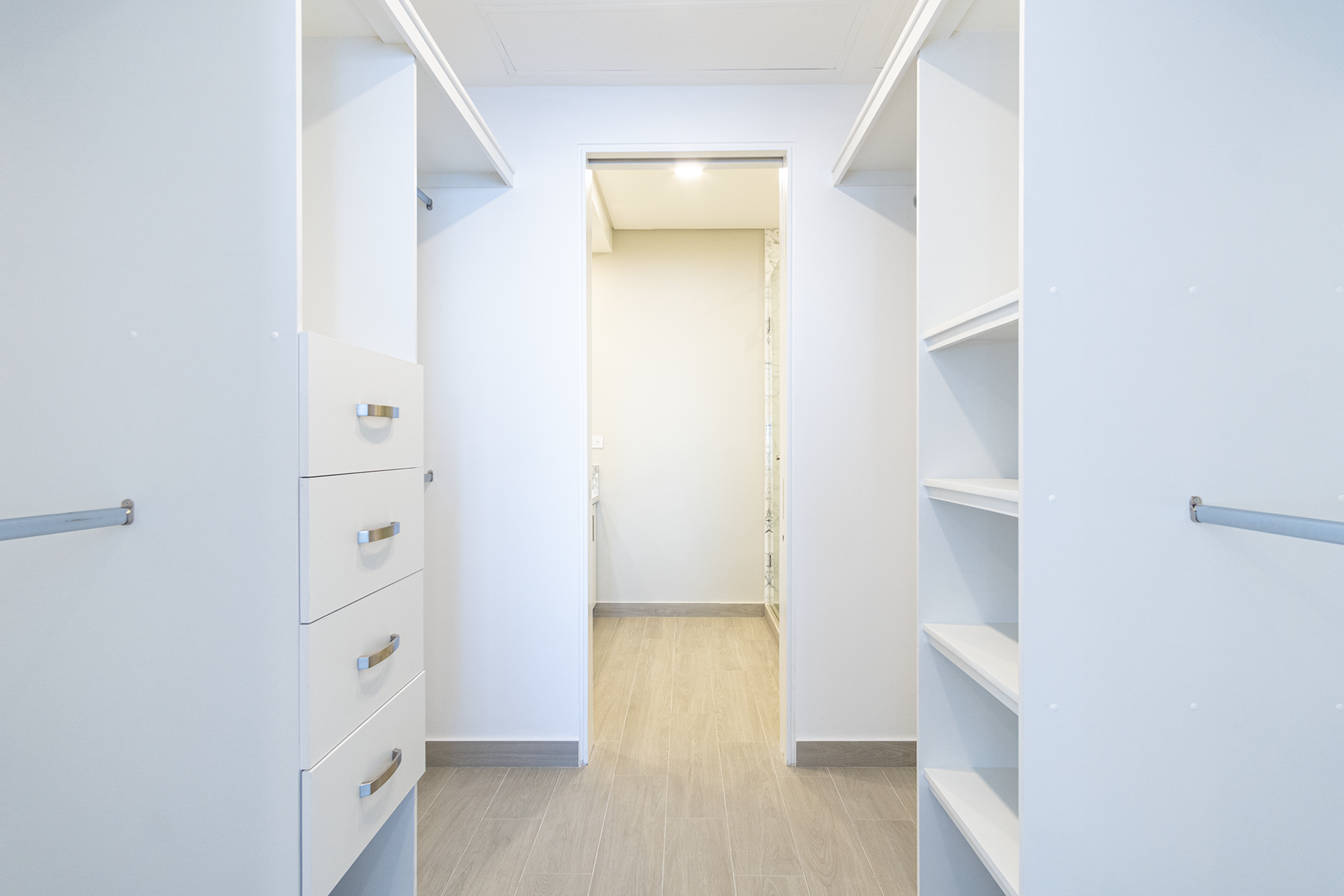 The large walk-through closet of the main bedroom.