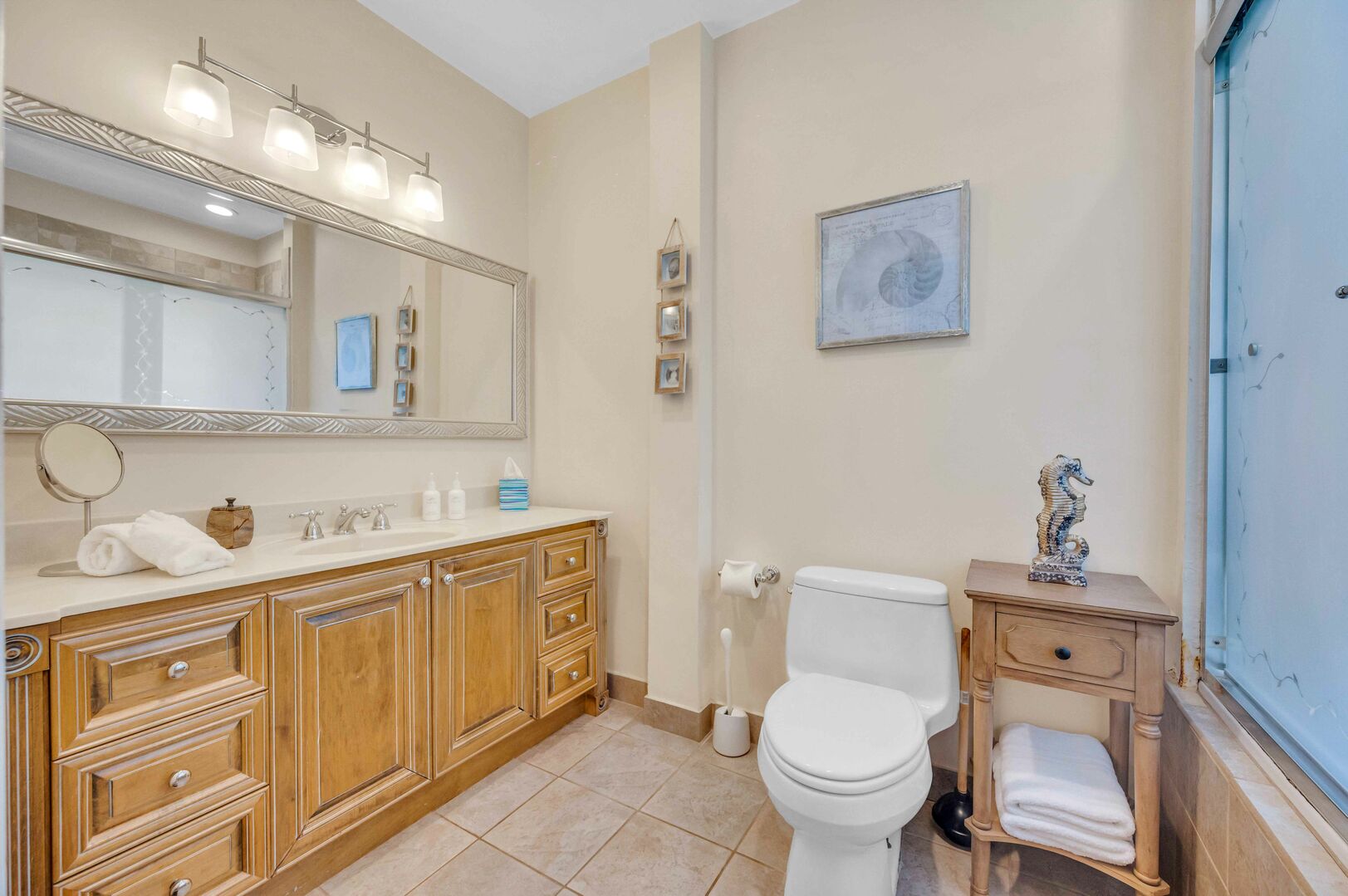 Primary bathroom with dual vanities and Tub/Shower combo.