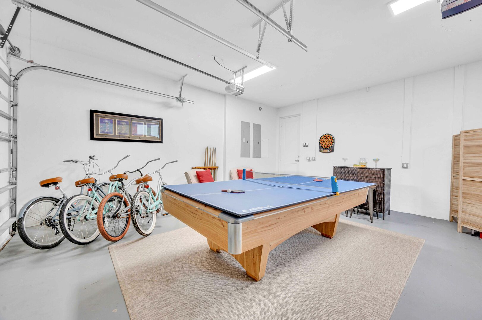 This game room has plenty of seating and includes both a Ping-Pong table and a pool table.