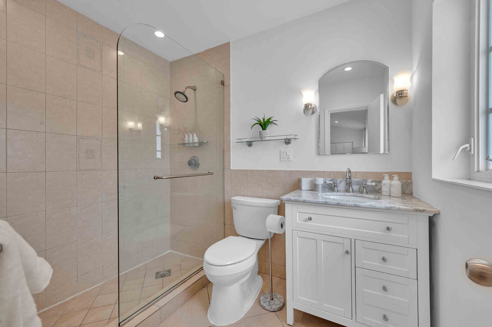 The master bathroom is quaint, with a walk-in shower.