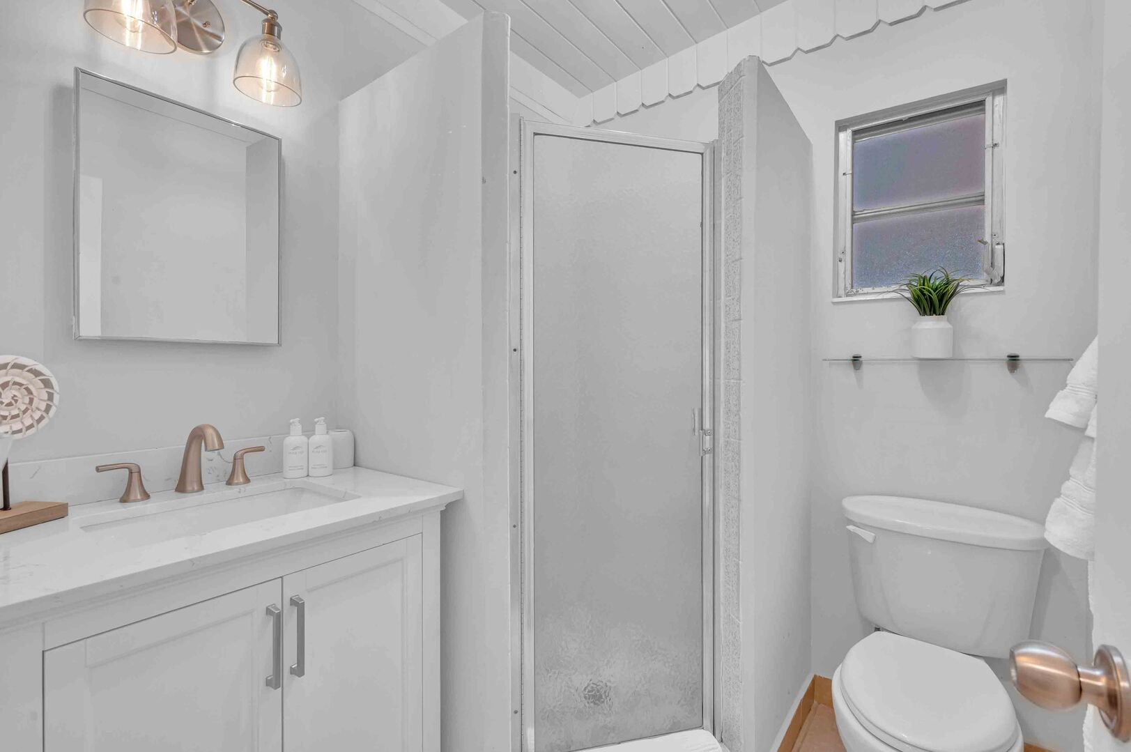 The second bedroom bath is located just outside the bedroom door and features a walk-in shower.