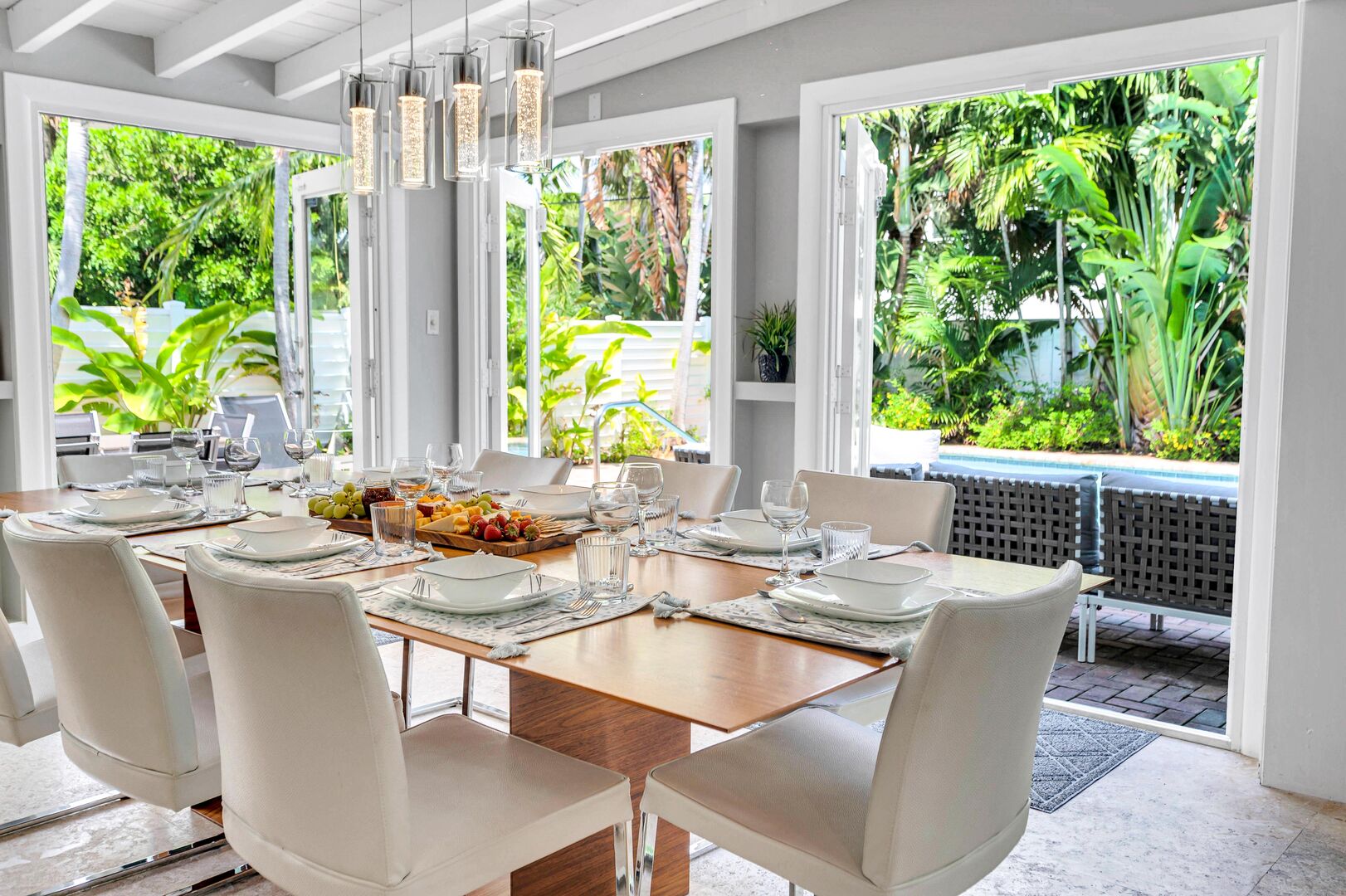 The dining room with its floor to ceiling windows offers pool views while letting in the year-round Florida sun.
