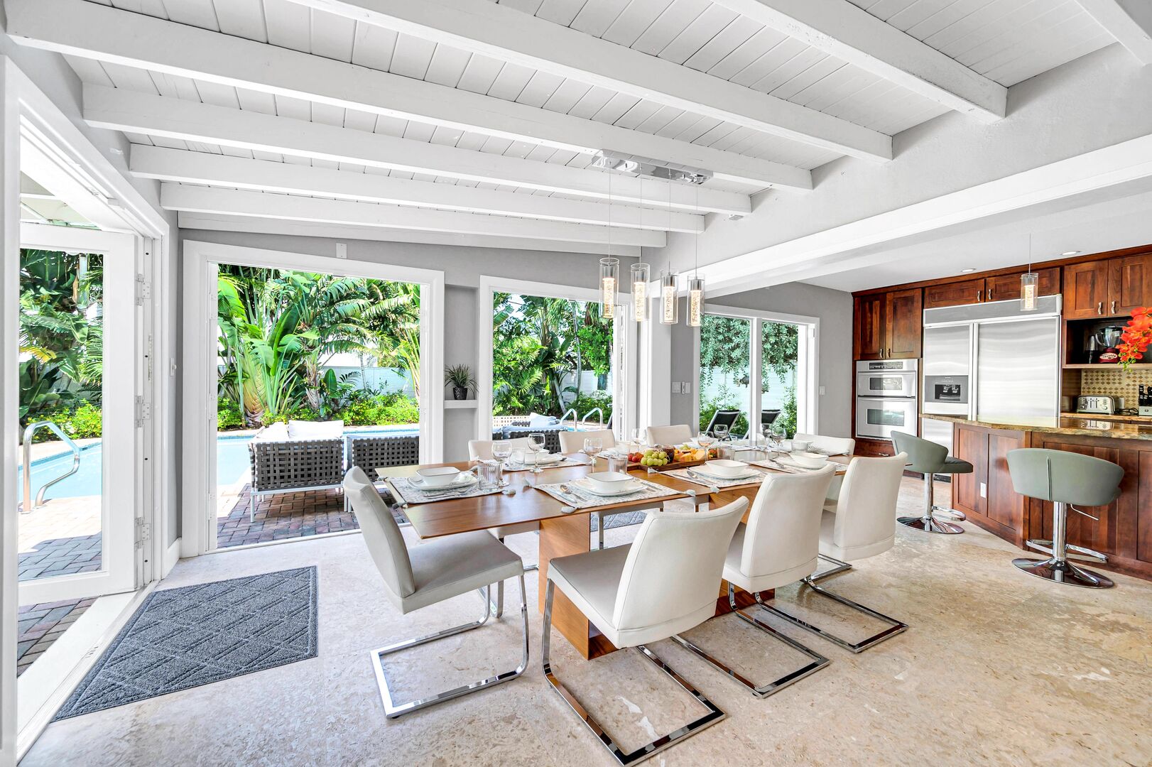 The dining room with its floor to ceiling windows offers pool views while letting in the year-round Florida sun.