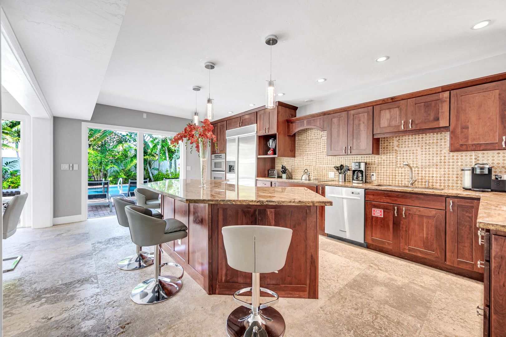 The kitchen comes with sleek countertops, modern appliances and bar seating for seven people.
