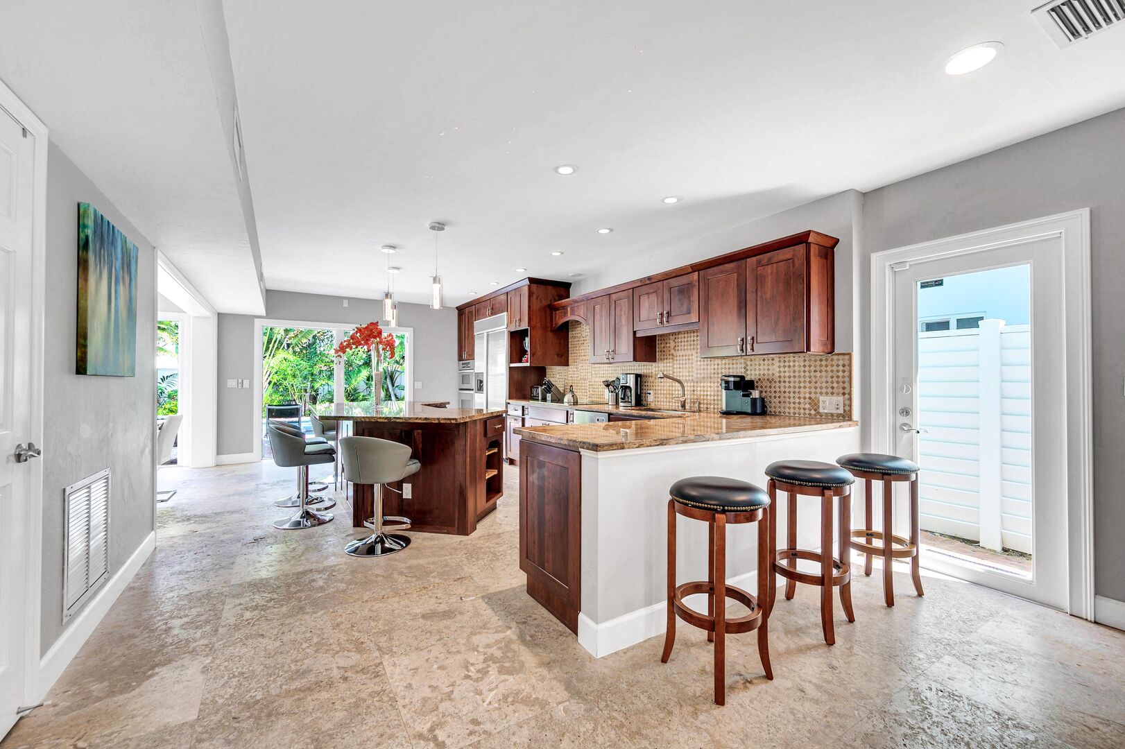 The kitchen comes with sleek countertops, modern appliances and bar seating for seven people.