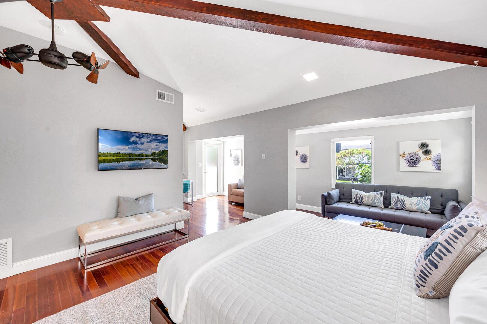 The master bedroom boasts a king size bed, access to the balcony, extra seating and a Smart T.V.