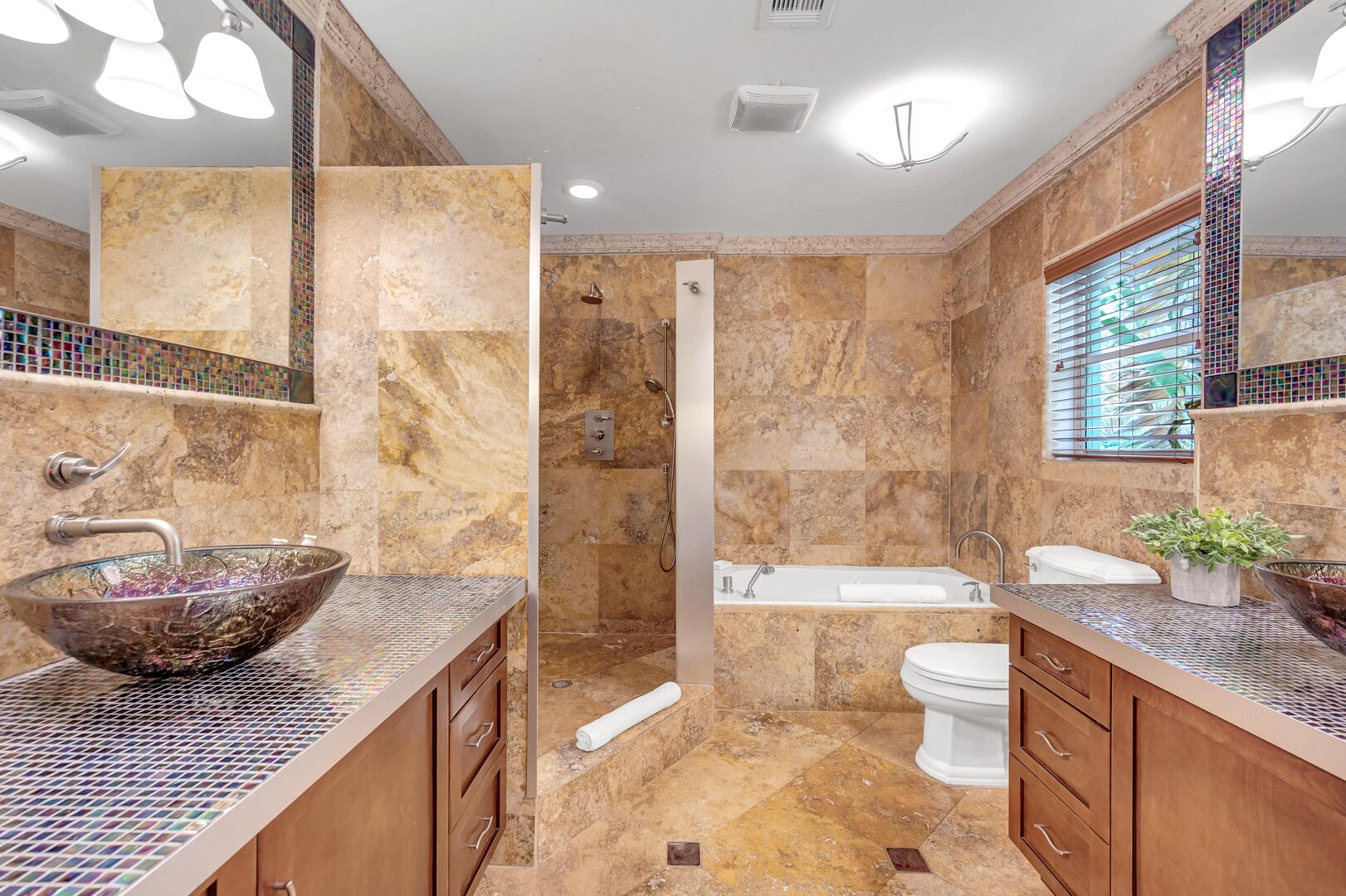 The master bedroom's bathroom features a walk-in shower and a tub.