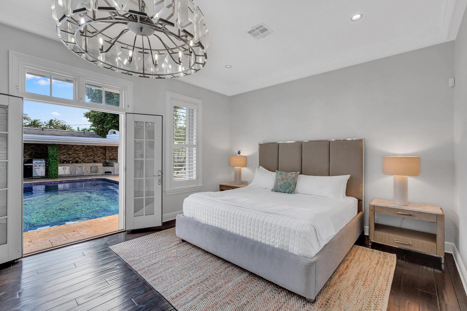 Bedroom four, featuring a king size bed and a Smart TV offers direct access to the heated pool.